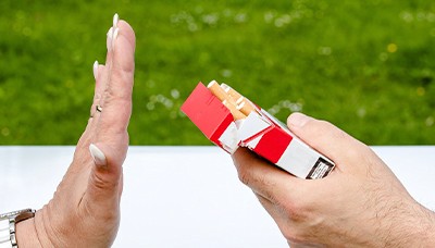 woman hand saying no to cigarette