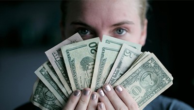 woman holding dollar bills