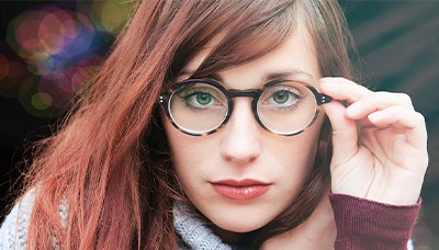 girl touching glasses frame