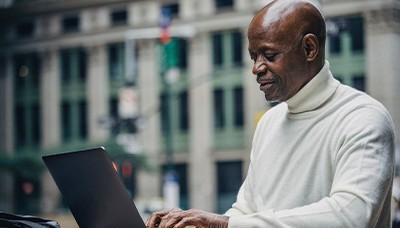 man working on laptop outside