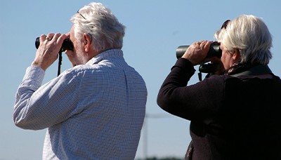 man and woman looking through Binoculars