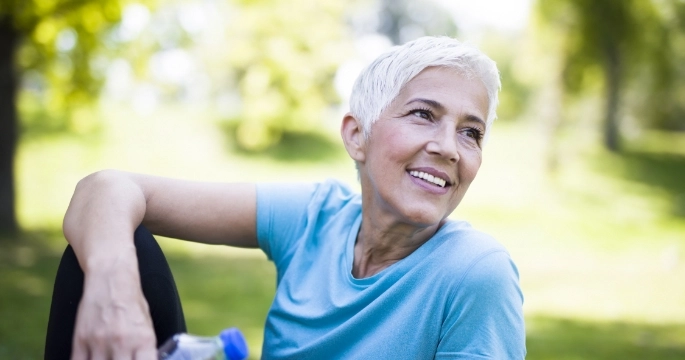 elderly lady sitting in a park